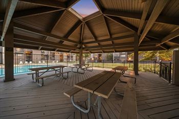 Covered wooden deck with picnic tables